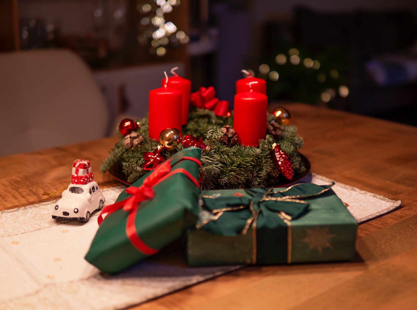 unlighted-red-advent-candles-on-table-beside-green-gift-1746191.jpg